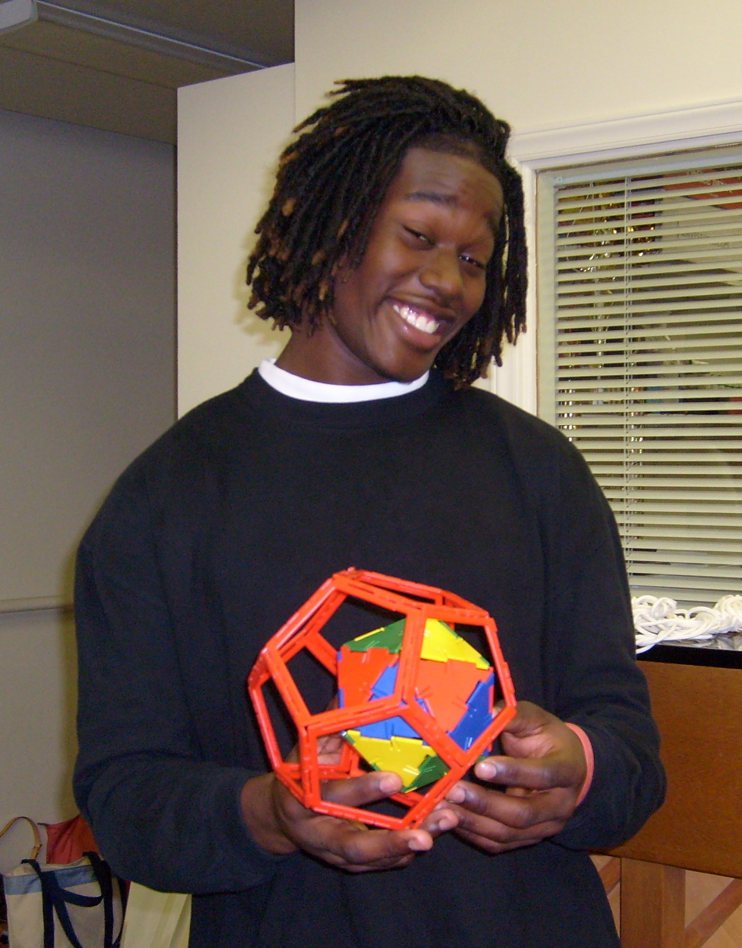 A student with a dodecahedron model